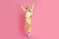 Full length photo of active elegant person raise hands jumping empty space isolated on pink color background