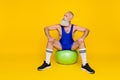 Full length photo of active energetic man coach siting fit ball look empty space hobby time offer isolated on yellow