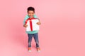 Full length photo of adorable little boy hold excited big giftbox wear trendy aquamarine garment isolated on pink color Royalty Free Stock Photo