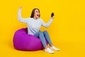 Full length photo of amazed young woman play game winner hold joystick isolated on yellow color background