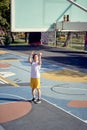 Full-length photo of athlete man throwing ball into basketball hoop on playground. Royalty Free Stock Photo