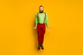 Full length photo of attractive funky guy jumping high up good mood rejoicing wear green shirt red suspenders pants Royalty Free Stock Photo