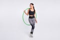 Full length photo of attractive pretty young woman hold hula hoop gym active  on grey color background Royalty Free Stock Photo