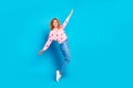 Full length photo of attractive young woman tiptoes dance look empty space dressed stylish pink clothes on blue