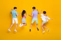 Full length photo of best buddies jump rear view raise hands up isolated bright color background Royalty Free Stock Photo