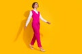 Full length photo of bossy millennial brunette lady go wear pink suit stilettos isolated on yellow background