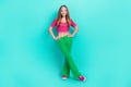 Full length photo of charming sweet schoolgirl wear pink crop top flared pants smiling walking isolated turquoise color