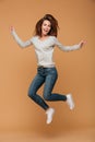 Full length photo of charming young woman in casual wear jumping