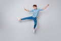 Full length photo of cheerful candid man jump raise hands legs imagine he child teen again wear casual style sneakers