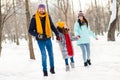 Full length photo of cheerful family happy positive smile enjoy time together holiday vacation winter park