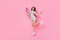 Full length photo of cheerful funny girl dressed off shoulders outfit jumping holding flowers empty space  pink Royalty Free Stock Photo