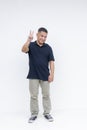 Full-length photo of a cheerful middle-aged Asian man making a peace sign against a white background Royalty Free Stock Photo