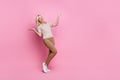 Full length photo of cheerful satisfied woman wear trendy clothes palms compering products empty space isolated on pink Royalty Free Stock Photo