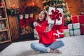 Full length photo of chilling crossed legs woman hold paper package shaking giftbox anticipation saint nicholas want Royalty Free Stock Photo