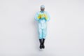 Full length photo clean hygiene man jump hold globe stop international ncov epidemic outbreak wear white suit hazmat