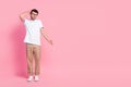 Full length photo of clueless attractive man stylish outfit look down arm direct empty space dont know isolated on pink Royalty Free Stock Photo