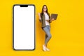 Full length photo of cool business lady recommend demonstrate new phone sale discount promo  on yellow color Royalty Free Stock Photo