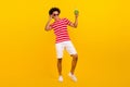 Full length photo of cool excited man dressed red t-shirt enjoying nonalcohol cocktail isolated yellow color background Royalty Free Stock Photo