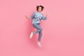 Full length photo of cool millennial lady jump wave wear jumper jeans footwear isolated on pink background Royalty Free Stock Photo