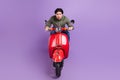 Full length photo of cool serious young man ride bike wear casual clothes isolated on violet color background