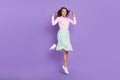 Full length photo of cool young brunette lady jump wear shirt skirt shoes isolated on purple background