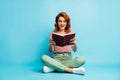 Full length photo of crazy book worm woman sit floor rest relax cross legs read book impressed scream wow omg wear white Royalty Free Stock Photo