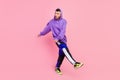 Full length photo of curious young brunet guy dance wear hoodie pants shoes isolated on pink color background