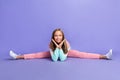 Full length photo of cute dreamy small girl wear sweatshirt arms hands cheeks stretching isolated violet color
