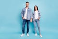 Full length photo of cute people smiling wearing denim jeans jackets isolated over blue background