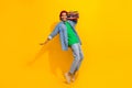 Full length photo of cute young male dancer tape recorder have fun wear trendy jeans garment isolated on yellow color Royalty Free Stock Photo