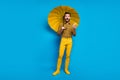 Full length photo energetic guy use smartphone get comment impressed scream omg hold protect rainstorm shield parasol