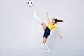 Full length photo energetic soccer player girl last hope for 2020 world championship match kick ball high try score goal