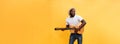 Full-length photo of excited artistic man playing his guitar in casual suite. Isolated on yellow background. Royalty Free Stock Photo