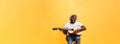 Full-length photo of excited artistic man playing his guitar.  on yellow background. Royalty Free Stock Photo