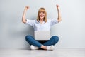 Full length photo of excited boss lady sit floor crossed legs fists up invest savings win wear denim grey color