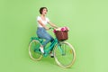 Full length photo of excited funky lady wear white top riding fast bicycle isolated green color background