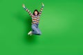 Full length photo excited lucky young lady dressed colorful pullover jumping high rising arms isolated green color