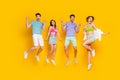 Full length photo of excited people jumping enjoy discount make v sign raise hands up isolated shine color background Royalty Free Stock Photo