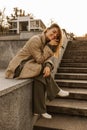 Full-length photo of fair-skinned young girl on the stairs of old city. Royalty Free Stock Photo