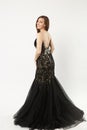Full length photo of fashion model woman wearing elegant evening dress black gown posing isolated on white wall Royalty Free Stock Photo