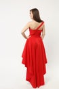 Full length photo of fashion model woman wearing elegant evening dress red gown posing isolated on white wall background Royalty Free Stock Photo