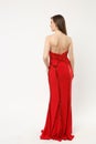 Full length photo of fashion model woman wearing elegant evening dress red gown posing isolated on white wall background Royalty Free Stock Photo