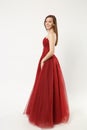 Full length photo fashion model woman wearing elegant evening dress red gown posing isolated on white wall background Royalty Free Stock Photo