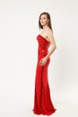 Full length photo fashion model woman wearing elegant evening dress red gown posing isolated on white wall background Royalty Free Stock Photo