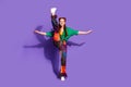 Full length photo flexy girl wear print trousers vintage shirt dancing impressively raising up feet isolated on violet Royalty Free Stock Photo