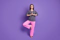 Full length photo of focused girl train yoga workout exercise raise leg put hands together wear pink dotted pajama pants