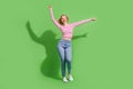 Full length photo of funky cheerful girl dressed striped shirt having fun dancing discotheque isolated green color Royalty Free Stock Photo