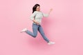 Full length photo of funky cheerful young woman jump up play imagine guitar isolated on pink color background Royalty Free Stock Photo