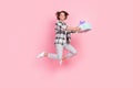 Full length photo of funky millennial brunette lady jump give present wear shirt trousers shoes isolated on pink