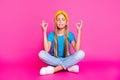 Full length photo of funky peaceful calm kid sit with her legs crossed practice yoga meditate om wear blue denim jeans